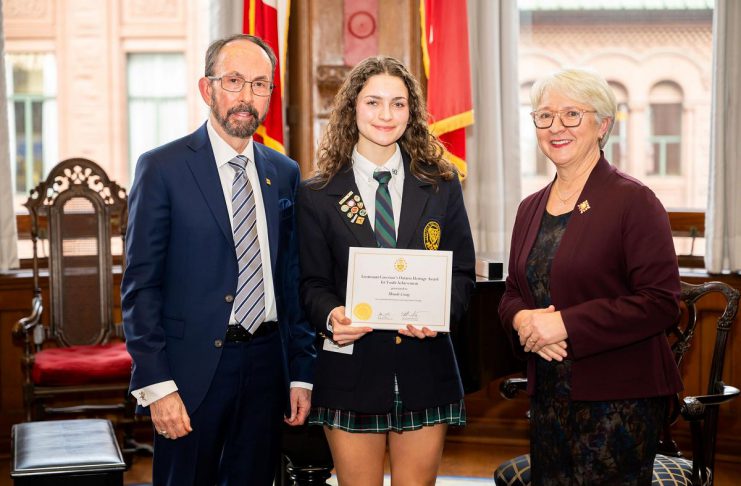 Maude Rose Craig with her Lieutenant Governor's Ontario Heritage Award for Youth Achievement, flanked by Ontario Heritage Trust board chair John Ecker and Ontario's lieutenant governor Edith Dumont, at the awards ceremony in Toronto on February 22, 2024. (Photo: Dahlia Katz)