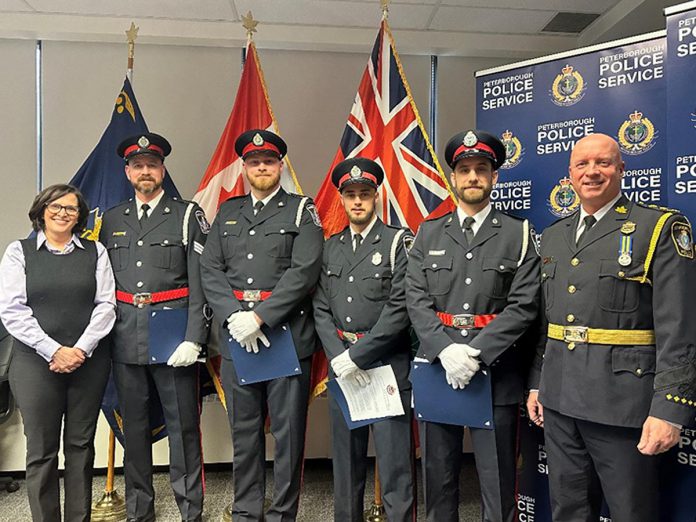 Peterborough police services board chair Mary ten Doeschate (left) and police chief Stuart Betts (far right) with officers Mike Self, Josh Gibbs, Nick Gannon, and Mitchell Northey, who were commended for their actions in response to an armed stand-off at a Peterborough car dealership last August that ended with the suspect taking his own life. (Photo: Peterborough Police Service)