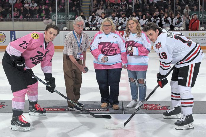 The puck drop for the Peterborough Petes' 15th annual Pink in the Rink game at the Peterborough Memorial Centre on February 3, 2024. Despite losing in overtime to the Niagara IceDogs, the Petes organization achieved its goal of breaking $1 million in funds raised for cancer care over the past 15 years of the annual game. (Photo: Kenneth Andersen Photography)