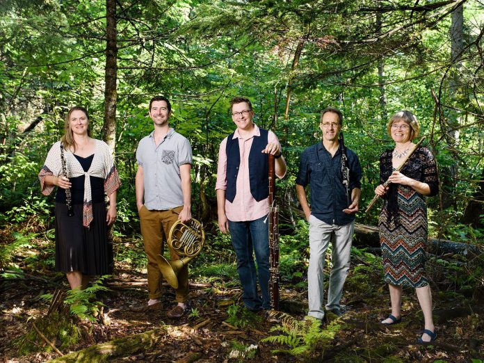 Oboist Christie Goodwin (left) and her bassoonist husband Patrick Bolduc (third from left) were founding members of Ventus Machina, a well-known New Brunswick-based woodwind quintet that also features (left to right) Jon Fisher on horn, James Kalyn on clarinet and saxophone, and Karin Aurell on flute. Although the couple have now left the quintet after their move back to Peterborough, Ventus Machina will continue on. (Photo: Denis Duquette Photography)