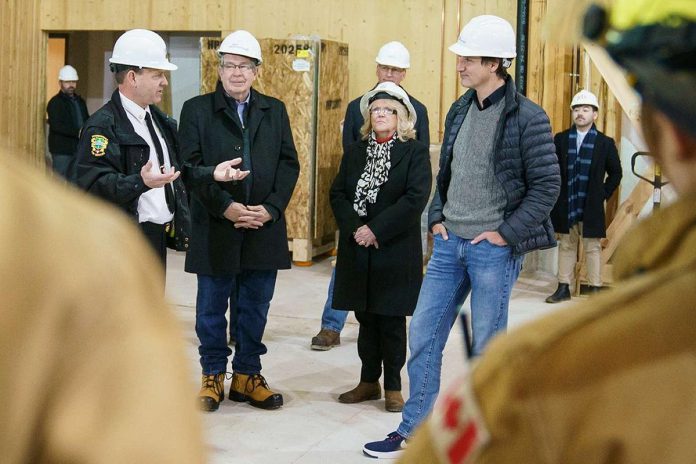 Prime Minister Justin Trudeau listens to Peterborough Fire Services chief Chris Snetsinger during an unpublicized visit on February 8, 2024 to the city's new $10-million net zero carbon fire station under construction at 100 Marina Boulevard. Also pictured are Peterborough mayor Jeff Leal and Peterborough County warden Bonnie Clark. (Photo: City of Peterborough)