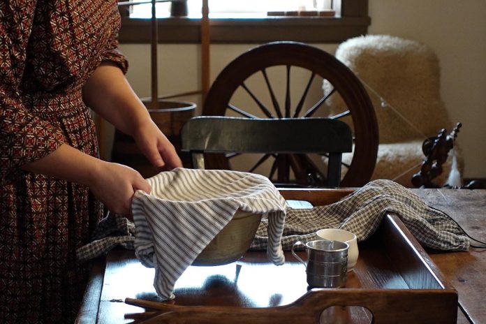 For her master's thesis in public history at Carelton University, Holly Benison is filming her "The Backwoods Kitchen" video series at the Fitzpatrick House at Lang Pioneer Village in Keene, a living history musueum not far from where 19th-century Catharine Parr Traill settled in Lakefield. For the historian, making videos about Traill's 19th-century recipes along with settler cooking techniques, tools, and wardrobe allows her to make her thesis more accessible.  (Screenshot courtesy of Holly Benison)