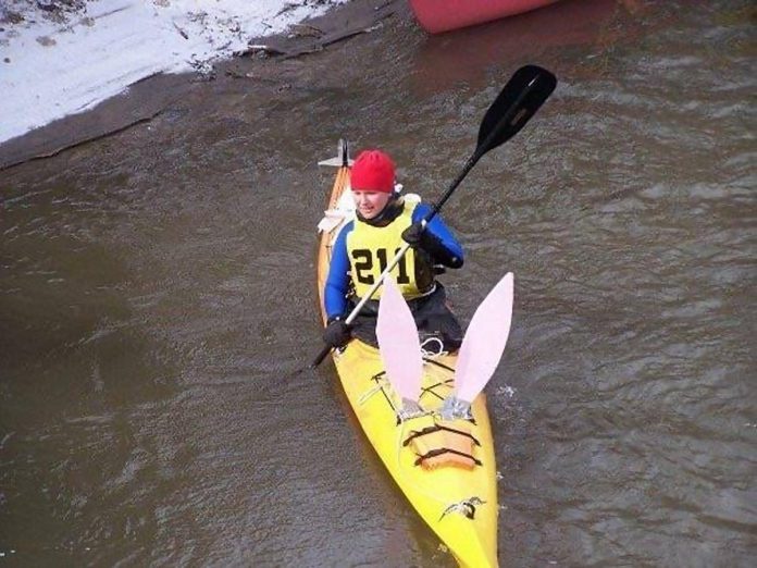 Newtonville resident Bridgetta Ballings participating in her first kayak race at Port Hope's "Float Your Fanny Down the Ganny" event around 20 years ago, decorating her kayak with bunny ears and a tail for Easter. She has participated nearly every year since in all categories, making it a beloved tradition with friends, her husband, and young children. (Photo courtesy of Bridgetta Ballings)