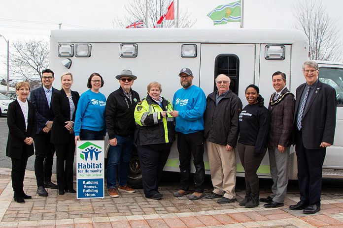 Northumberland Paramedics Chief Susan Brown (sixth from left) passes the keys of a decommissioned ambulance to Habitat for Humanity Northumberland construction manager Tobias Moeller on March 20, 2024. Also pictured from left to right are Northumberland County councillors Mandy Martin and Lucas Cleveland, deputy warden Olena Hankivsky, Habitat for Humanity Northumberland community and fund development co-ordinator Melissa Morrison, councillor Bob Crate, Habitat for Humanity Northumberland housing partnerships co-ordinator Aleecia Lugossy, warden Brian Ostrander, and councillor John Logel. (Photo: Northumberland county)