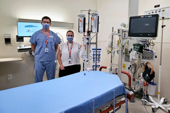 Peterborough Regional Health Centre's Trauma Medical Director, Dr. Troy Tebbenham (left), and Trauma Program Coordinator, Nicole Glover, stand with some of the cutting-edge, donor-funded equipment critical to the trauma team's ability to care for patients. Shown are a rapid blood transfusion machine (back centre) and an advanced stretcher (front). (Photo courtesy of the PRHC Foundation)