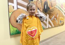 Five Counties Children's Centre client Tripp displays a McHappy Day shirt. The organization has been selected as the local children's charity that will benefit from McHappy Day on May 8, 2024 at McDonald's restaurants in Cobourg and Port Hope. (Photo: Five Counties Children's Centre)