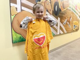 Five Counties Children's Centre client Tripp displays a McHappy Day shirt. The organization has been selected as the local children's charity that will benefit from McHappy Day on May 8, 2024 at McDonald's restaurants in Cobourg and Port Hope. (Photo: Five Counties Children's Centre)