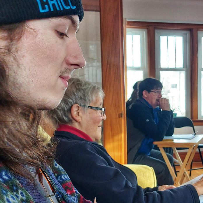 Actor Paden Gilhooley (left), co-prooducer Mary Conchelos (centre), and playwright Ed Schroeter (right, in the background at a script development workshop for Trent Valley Archives Theatre's "Tide of Hope". Public performances of the play will be staged May 15 and 16, 2024, at 7:30 p.m. at Market Hall Performing Arts Centre, with a performance for school groups at 1 p.m. on May 15. (Photo: Suzanne Schroeter)