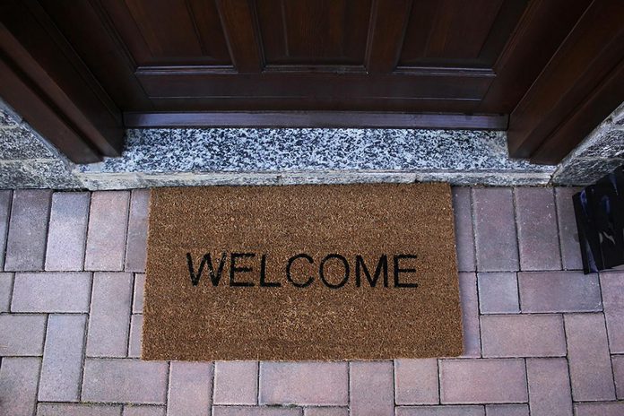 A welcome mat outside the door of a house. (Stock photo)