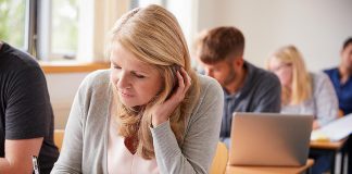 A mature female student in a classroom. (Stock photo)