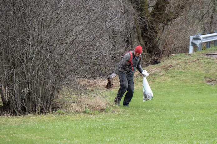 John Hauser cleaning up garbage on Armour Hill in Peterborough on April 13, 2024. (Photo: Scott Adams)