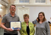 Kawartha Lakes resident Harold Lenters receiving a 2023 Bee a Hero certificate from Kawartha Lake city councillor Pat Warren and beekeeper Christine Szabados of the Kawartha Lakes environmental advisory committee at the April 9, 2024 committee of the whole meeting. Lenters, who added pollinator gardens to his waterfront property, was one of eight people and organizations who were recognized for their efforts to create pollinator-friendly gardens in Kawartha Lakes. (Photo courtesy of City of Kawartha Lakes)