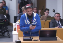 Food Not Bombs representative Ben Rempel reads a statement on behalf of the organization at the Peterborough city council meeting on April 8, 2024. (kawarthaNOW screenshot of City of Peterborough video)