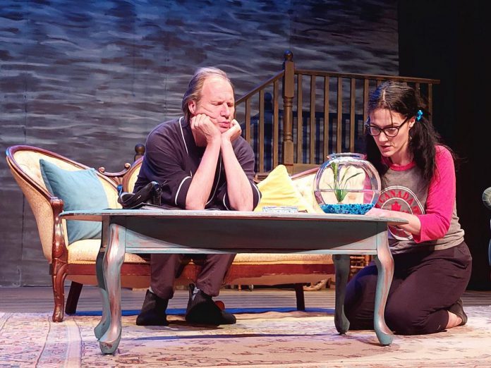 In "Girl in the Goldfish Bowl" by Morris Panych, 10-year-old Iris (Lindsay Wilson, right) is convinced a mysterious stranger named Mr. Lawrence (Stew Granger, left) is the reincarnation of her pet goldfish, whose death she believes has precipitated everything that has gone wrong in her world. The Peterborough Theatre Guild's production runs for 10 performances from May 3 to 18, 2024. (Photo courtesy of Peterborough Theatre Guild)