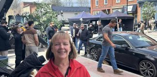 Nancy Britton of Millbrook Home Hardware with "Reacher" actor Alan Ritchson walking in front of a car during the filming of a third-season episode of the popular Amazon Prime Video action-thriller series in downtown Millbrook on April 23, 2024. (Photo: Millbrook Home Hardware / Facebook)