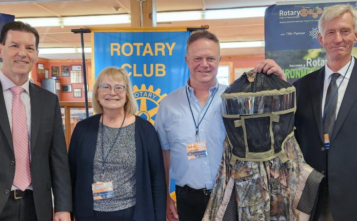 Joann Marcotte with Dave Furdas for Gerry Marcotte of Tick Suit (holding a sample suit) with the Rotary Environmentalist Innovators Fund's honorary champion Martin Yuill (left) and chair Graham Wilkins.  (Photo courtesy of Rotary Environmentalist Innovators Fund)