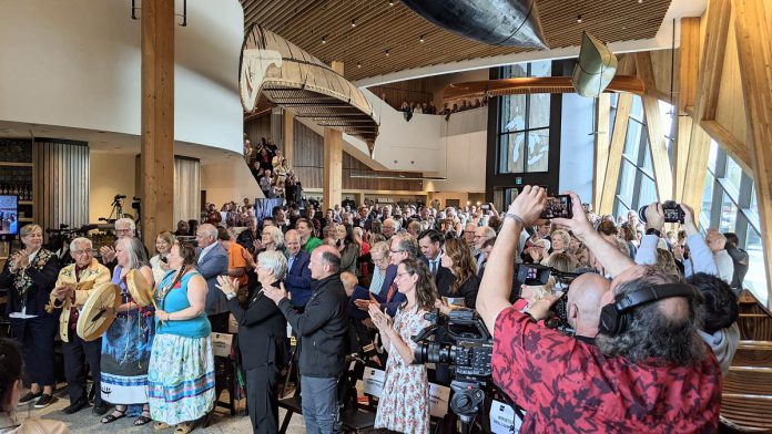 Attendees give a standing ovation for executive director Carolyn Hyslop during the grand opening celebration of the new Canadian Canoe Museum on May 11, 2024. (Photo: Bruce Head / kawarthaNOW)