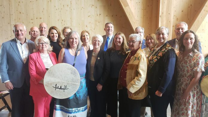 Dignitaries representing Indigenous peoples, the Crown, and federal, provincial, and municipal governments with Canadian Canoe Museum staff at the grand opening celebration of the new Canadian Canoe Museum on May 11, 2024. (Photo: Jeannine Taylor / kawarthaNOW)