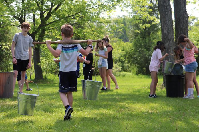 Students at the Peterborough Children's Water Festival participating in the settler water Race, where they examine the importance of water to the survival and success of area settlers. (Photo: Jessica Todd)