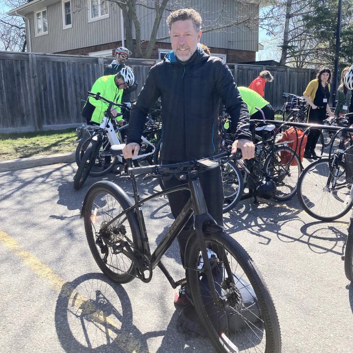 Inseparable from his bike, Kieran Andrews of Wild Rock Outfitters, a bike-friendly workplace and member of Green Economy Peterborough, shares his love of cycling with staff and the greater community. Wild Rock has long supported cycling organizations and events in the region, including the Peterborough Bicycle Advisory Committee and their recent Safe Streets for Everyone Cycling Summit. (Photo: Jackie Donaldson)