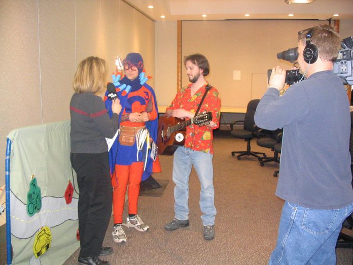 As part of Peterborough GreenUP's first annual Shifting Gears challenge in April 2004, "Paddling Puppeteers" Glen Caradus and Donald Fraser are interviewed by CHEX News Watch in 2004 to encourage the community to move towards more sustainable modes of transportation. (Photo: GreenUP)