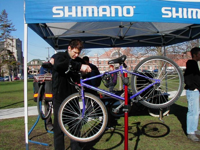 Shimano staff members assist morning commuters to tune-up their bikes during the first annual Shifting Gears May Challenge in April 2004. Shimano was a supporting sponsor. (Photo: GreenUP)