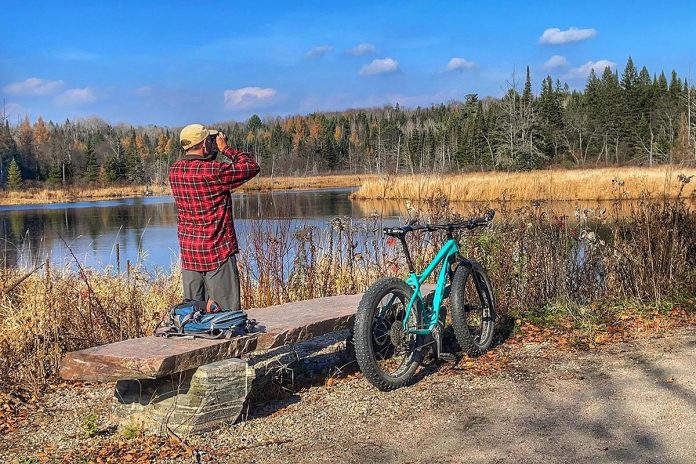 Because of its location along significant wetlands, the Haliburton County Rail Trail has some of the best birding and wildlife viewing spots in the Haliburton Highlands. The landmark stone benches along the way and flat trail makes it a go-to picnic spot. (Photo courtesy of Haliburton Highlands Economic Development & Tourism)