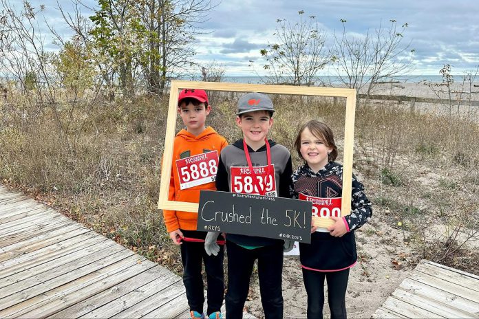 Three young participants along the Cobourg waterfront after last year's 'Kilometers for Kids' fundraising walk and run supporting Rebound Child & Youth Services. This year's event takes place on May 26, 2024 and features five and 10 kilometre routes, with proceeds supporting local mental health services for children and youth and their families. (Photo: Rebound Child & Youth Services)