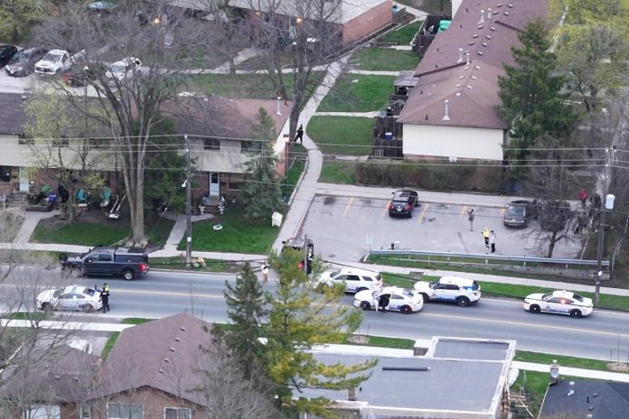 Multiple police vehicles at a residence at 850 Fairbairn Street on April 30, 2024. (kawarthaNOW screenshot of Brian Parypa video)