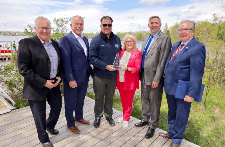 Water Ways TV executive producer and host Steven Bull (third from left) holds the inaugural Water Ways Destination of the Year award with Peterborough County warden Bonnie Clark during an event on May 15, 2024. Also pictured from left to right are Peterborough & the Kawarthas Economic Development director of tourism Joe Rees, Ontario minister of tourism, sport, and culture Neil Lumsden, Peterborough-Kawartha MPP Dave Smith, and Peterborough mayor Jeff Leal. (Photo: Ed Ed Middleton)