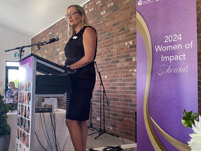 Anne Ondercin, director of philanthropy at United Way of Peterborough & District, makes opening remarks during the inaugural Women of Impact Awards ceremony and celebration, hosted by the United Way in conjunction with Women United Peterborough and held at Farmhill Weddings east of Peterborough on May 30, 2024. (Photo: Paul Rellinger / kawarthaNOW)