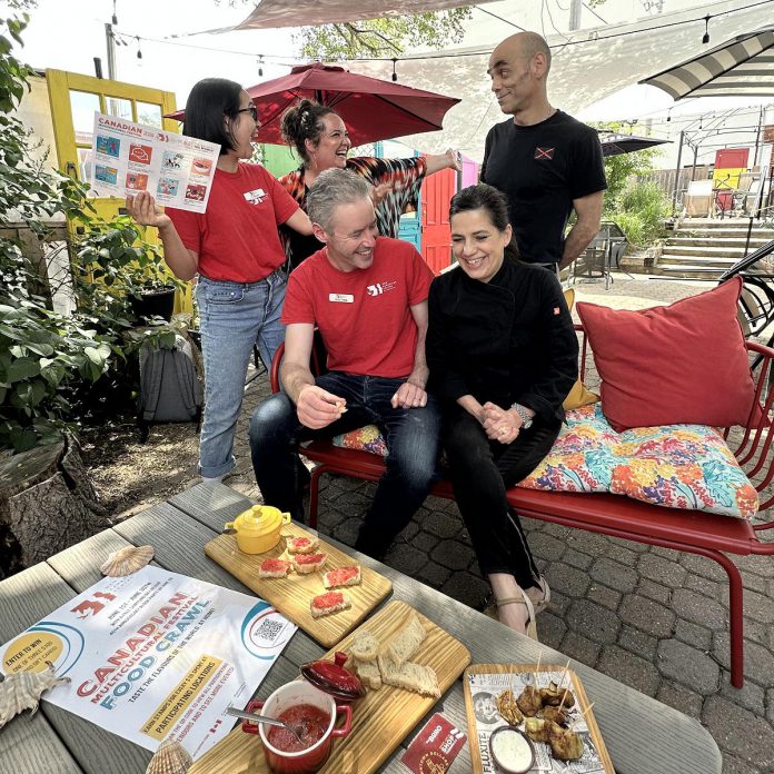 New Canadians Centre executive director Andy Cragg with Fresh Dreams co-owner Monica Silva during the launch of the Multicultural Food Crawl on June 4, 2024 at Fresh Dreams, one of the 10 downtown restaurants participating in the food crawl, which kicks off the  third annual Canadian Multicultural Festival running until June 28. Also pictured are New Canadians Centre community engagement assistant Tu Nguyen, Peterborough DBIA vibrancy manager Hillary Flood, and Fresh Dreams co-owner Alvaro De La Guardia. (Photo courtesy of New Canadians Centre)