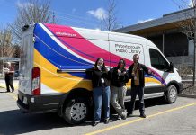 Jadyn Gay, Becky Waldman, and Mark Stewart of the Peterborough Public Library celebrate the library's new electric delivery van, the first fully electric vehicle in the City of Peterborough's fleet. The library will use the van for outreach events and to move materials between library kiosk locations and the new library branch opening at the Miskin Law Community Complex at Morrow Park. (Photo: City of Peterborough)
