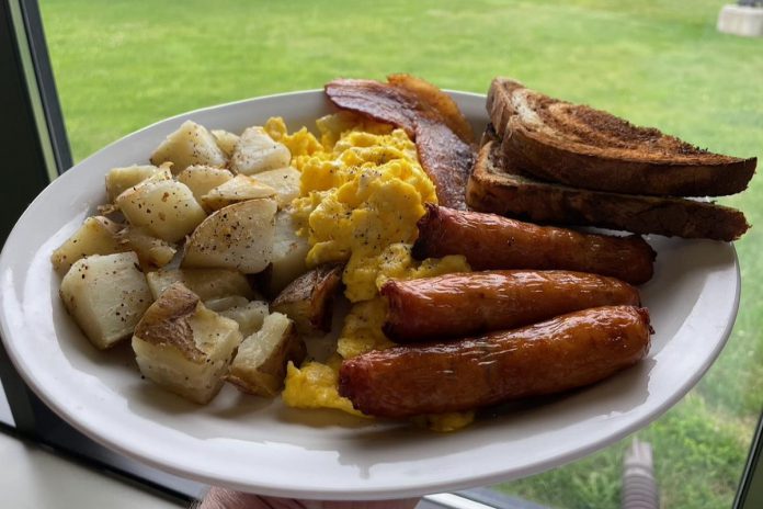 "The Otter", featuring three eggs, three slices of bacon, three sausage links, and home fries and toast, is one of the large breakfast plates found on the menu at The Good Baker YPQ. All menu items, including chicken fingers, burger patties, soups, and dressings are made in house, with gluten-free bread available upon request. (Photo courtesy of The Good Baker YPQ)