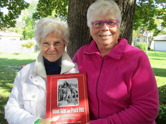 Shirleyan English and Bonnie Sitter with their 2019 book "Onion Skins & Peach Fuzz: Memories of Ontario Farmerettes," upon which 4th Line Theatre's play "Onion Skins & Peach Fuzz: The Farmerettes" is based. The book features letters, photos, and stories of young women's experiences working on Ontario farms during the labour shortage of the Second World War. (Photo: Age Creatively website)