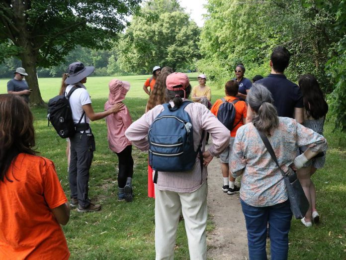 Diverse Nature Collective founder Patricia Wilson leading participants on a guided medicine walk around Beavermead Park during the New Canadians Centre's "Lessons from the Land" event on July 1, 2023. For the 2024 event, Wilson will be joined by Canadian Bushcraft head instructor Caleb Musgrave for a nature-connecting trek through Nicholls Oval Park in Nogojiwanong-Peterborough. (Photo: New Canadians Centre)