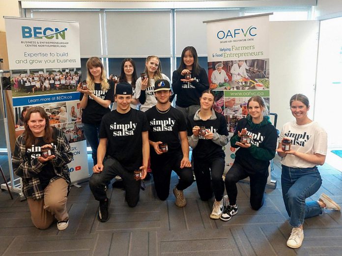 Some of the students from Cobourg Collegiate Institute's Grade 12 business class holding their retail-ready "Simply Salsa" products at the Ontario Agri-Food Venture Centre (OAFVC) in Colborne. OAFVC is hosting a free open house on June 15, 2024 where visitors can tour the 216 Purdy Road facility and learn more about OAFVC. (Photo: Northumberland County)