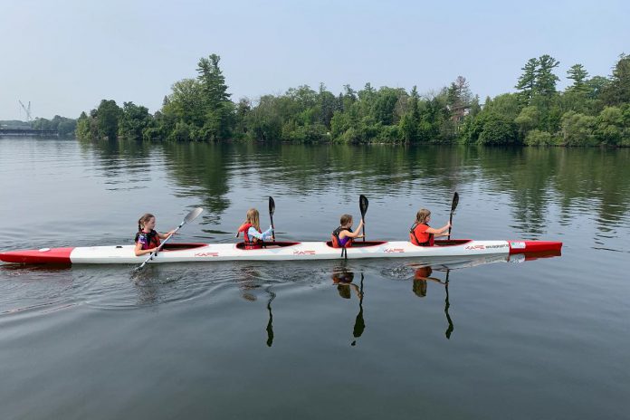 Youth who are just learning to paddle can benefit from being in a crew boat with more experienced paddlers so, for example, they can work on their paddling technique without worrying about maintaining balance. (Photo courtesy of Peterborough Canoe and Kayak Club)