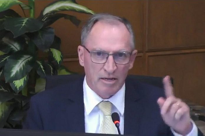 Councillor Dave Haacke makes a point during a discussion at city council's meeting on June 24, 2024 about the city's plan to take economic development and tourism services in-house after a decision not to renew a funding agreement with Peterborough & the Kawarthas Economic Development at the end of the year. Haacke was one of three councillors who changed their vote after council had unanimously supported the plan when meeting as general committee on June 17. (kawarthaNOW screenshot of City of Peterborough video)