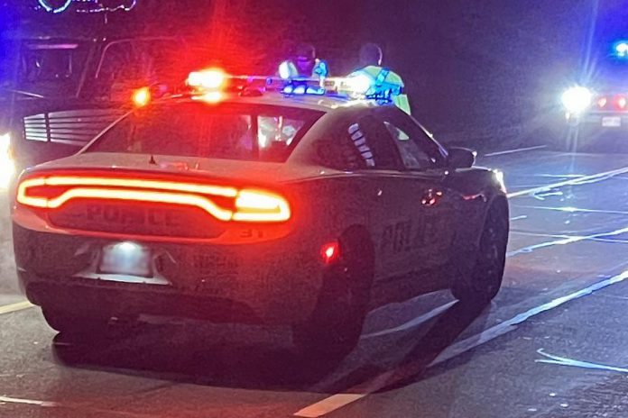 A Peterborough police car with light flashing at night. (Photo: Peterborough Police Service)
