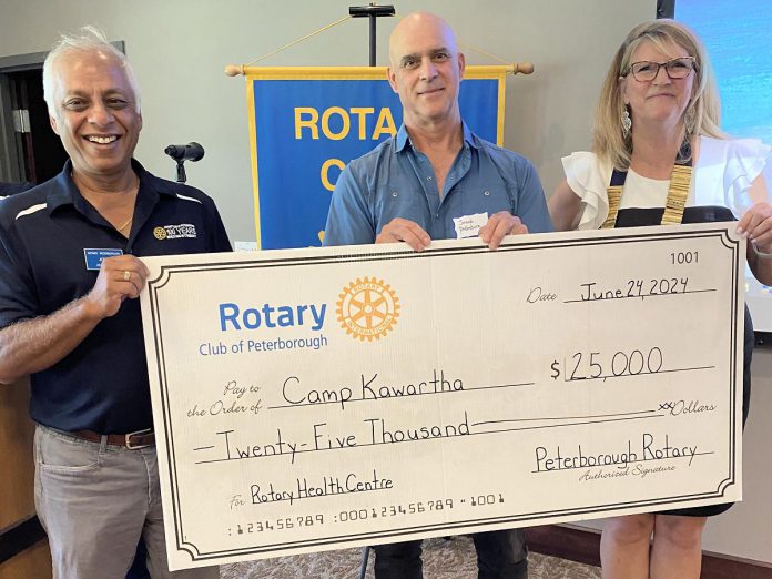 Rotary assistant district governor Atul Swarup (left) and outgoing Rotary Club of Peterborough president Betty Halman-Plumley presented a $25,000 cheque to Camp Kawartha executive director Jacob Rodenburg at the club's meeting on June 24, 2024. In 2021, the Rotary Club of Peterborough committed to donate $100,000 to Camp Kawartha to support its new eco-friendly health centre. (Photo courtesy of Rotary Club of Peterborough)