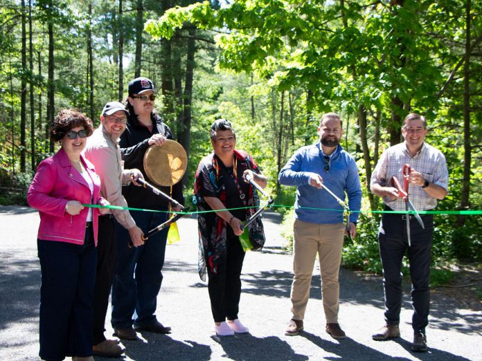 A ribbon-cutting ceremony for the Porcupine Universal Trail, the third accessible trail in the Northumberland County Forest, was held on May 31, 2024. Pictured from left to right are Northumberland County's CAO Jennifer Moore and natural heritage manager Todd Farrell, Alderville First Nation's cultural advisor Aiden Gorveatt and community engagement planner Jennifer Niles, Northumberland-Peterborough South MPP David Piccini, and Northumberland County Warden Brian Ostrander. (Photo: Northumberland County)