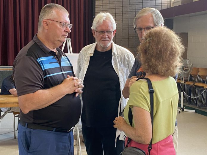 Ashburnham Ward councillor Gary Baldwin (left) speaking with attendees during an open house on June 20, 2024 about TVM Group's proposed 10-storey residential-commercial development just west of Mark Street United Church. TVM Group will need to have both a zoning bylaw amendment and a site plan application approved by the City of Peterborough before the development can proceed. (Photo: Paul Rellinger / kawarthaNOW)