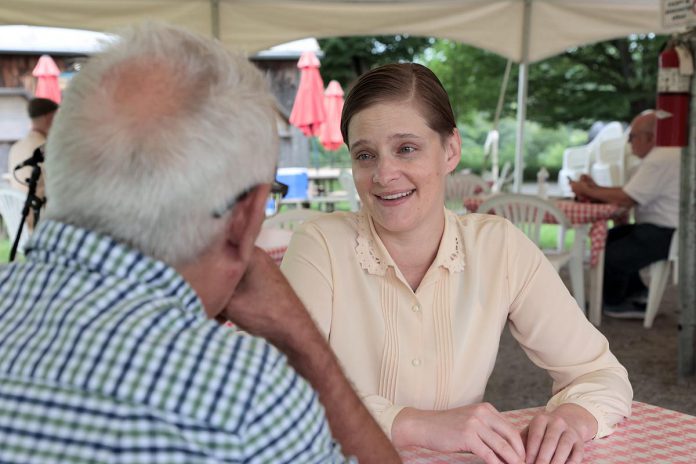 Actor Katie Ryerson speaks with kawarthaNOW's Paul Rellinger during a media day event for 4th Line Theatre's "Jim Watts: Girl Reporter" on July 17, 2024 at the Winslow Farm in Millbrook. Ryerson portrays Jean "Jim" Watts, a journalist who goes to Spain to report on the Spanish Civil War and becomes an ambulance driver with the volunteer Canadian Mackenzie–Papineau Battalion. (Photo: Heather Doughty / kawarthaNOW)