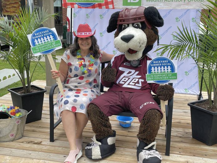 Five Counties Children's Centre board chair Julie Davis and Peterborough Petes mascot Roger were among the guests who helped kick off summer at the third annual Backyard Summer Social on June 22, 2024. The forecasted rain held off for the adults-only outdoor event event organized by Five Counties Children's Centre that raised nearly $42,000 to support kids' treatment services in Peterborough, Northumberland, Haliburton, and Hastings counties and in the City of Kawartha Lakes. (Photo: Five Counties Children's Centre)