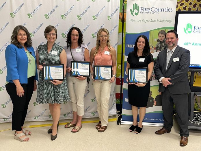 Five Counties Children's Centre board chair Julie Davis (far left) and Centre CEO Scott Pepin (far right) with four of the seven High-Five Community Recognition Awards recipients at the non-profit organization's annual meeting in late June 2024. Five Counties presents the awards each year to deserving individuals and groups that support and share the agency's vision of inclusion. (Photo: Five Counties Children's Centre)