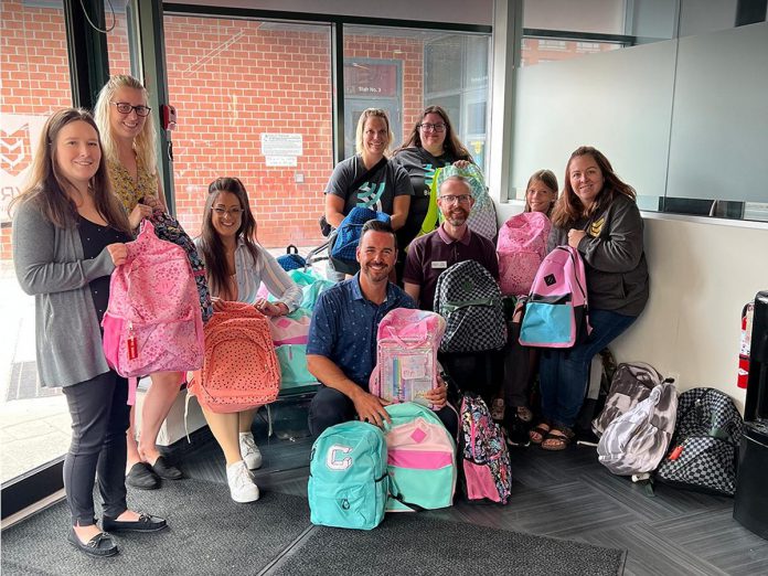 Gauvreau Accounting Tax Law Advisory founder and CEO Robert Gauvreau (front middle) pictured during 2023's Gear Up for Good" campaign, which helps ensure local children in need have backpacks and other school essentials in the fall. The third annual campaign is collecting donations until August 16 and the supplies will be distributed to on August 23. (Photo: Gauvreau Accounting Tax Law Advisory / Facebook)