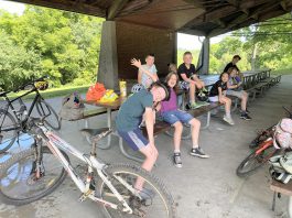 Participants in Peterborough GreenUP's new Urban Bike Adventures Camp take a well-deserved rest at Nicholls Oval Pavilion. Throughout the week, riders get more and more comfortable in the saddle with group rides, travelling to destinations including Ecology Park, Beavermead Park, Riverview Park & Zoo, and Jackson Park. (Photo: Natalie Stephenson / GreenUP)