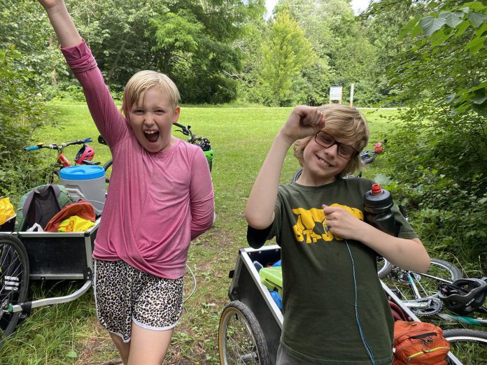 Urban Bike Adventures campers Evelyn and Jack expressing their excitement for biking and nearby nature. (Photo: Natalie Stephenson / GreenUP)