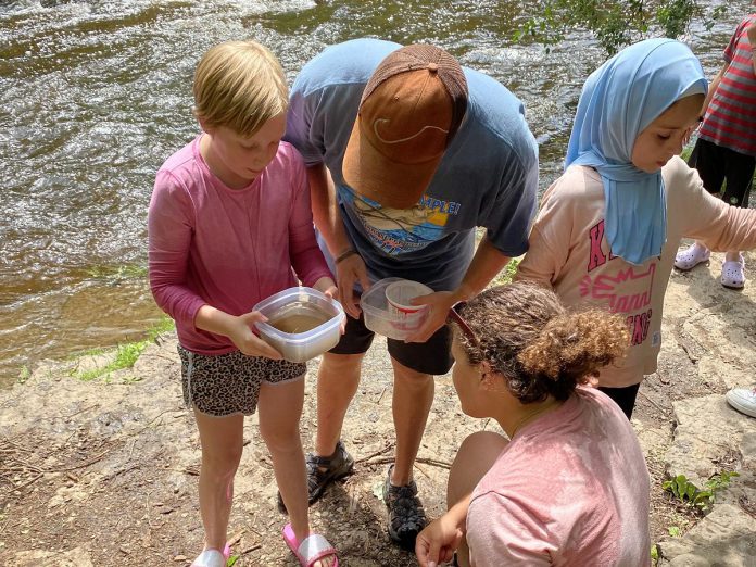 Urban Bike Adventure campers explore local biodiversity during a visit to Jackson Creek in mid-July. (Photo: Natalie Stephenson / GreenUP)